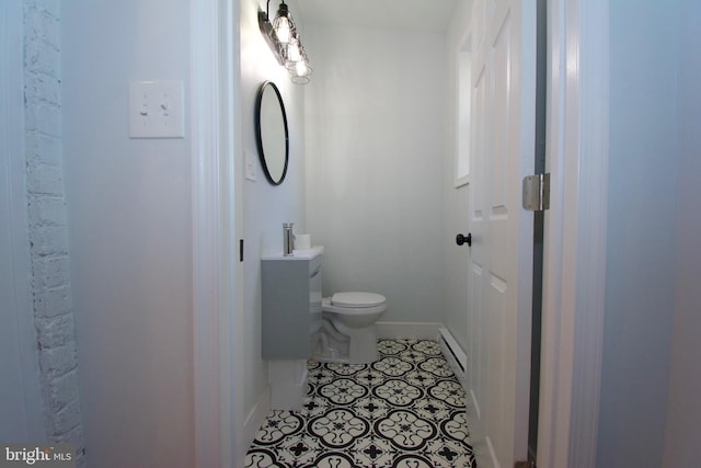 bathroom with tile patterned floors, toilet, and baseboard heating