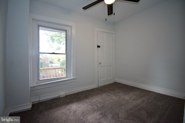 carpeted spare room featuring ceiling fan