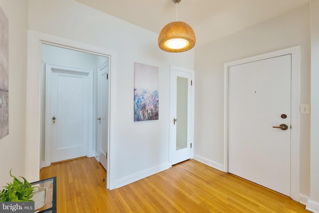 entryway featuring light wood-type flooring and baseboards