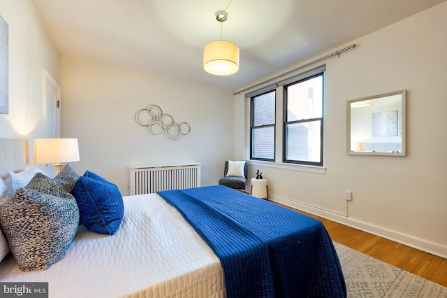 bedroom with wood finished floors and baseboards