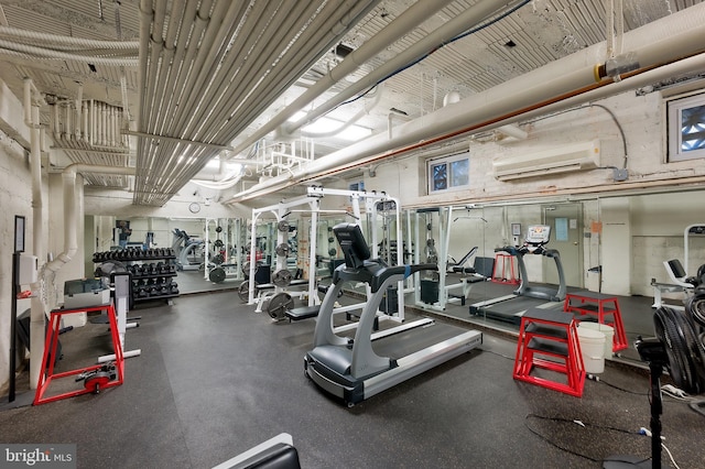 workout area featuring a wall mounted air conditioner