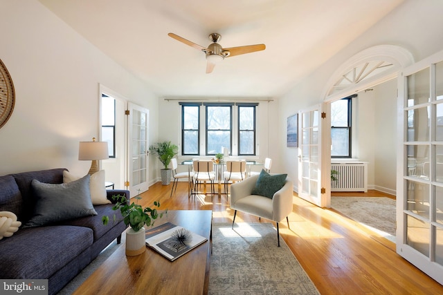 interior space featuring french doors, radiator heating unit, and a ceiling fan