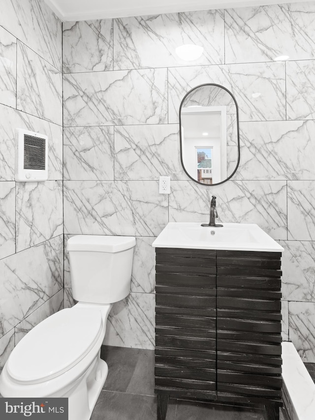 bathroom with visible vents, vanity, and toilet