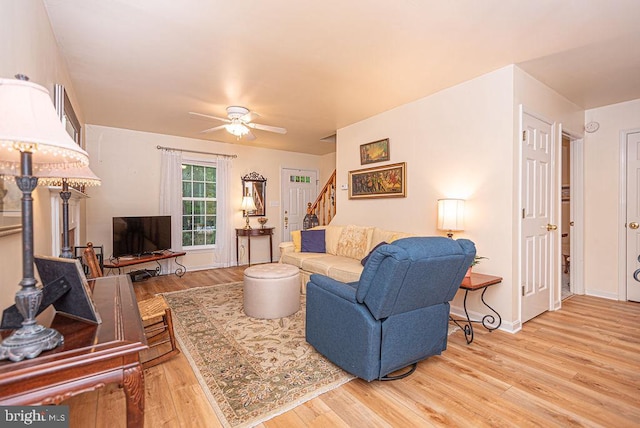 living room with ceiling fan and light hardwood / wood-style flooring