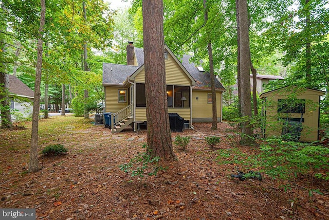 back of house with central AC