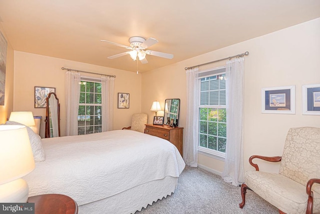 bedroom featuring multiple windows, carpet floors, and ceiling fan