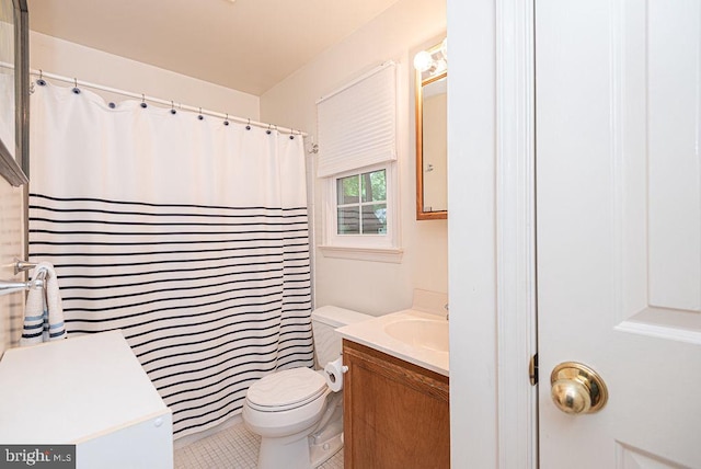 bathroom featuring toilet, tile patterned flooring, and vanity