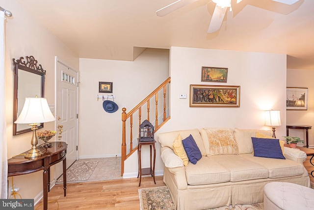 living room with ceiling fan and light hardwood / wood-style flooring