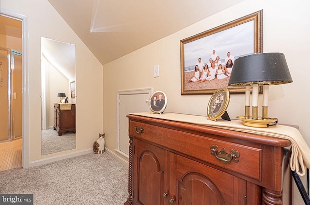 hall with light carpet and lofted ceiling