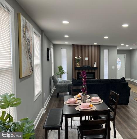 dining area with dark wood-type flooring and a healthy amount of sunlight