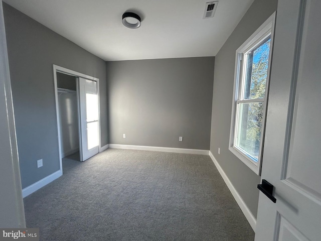 unfurnished bedroom with a closet and carpet flooring