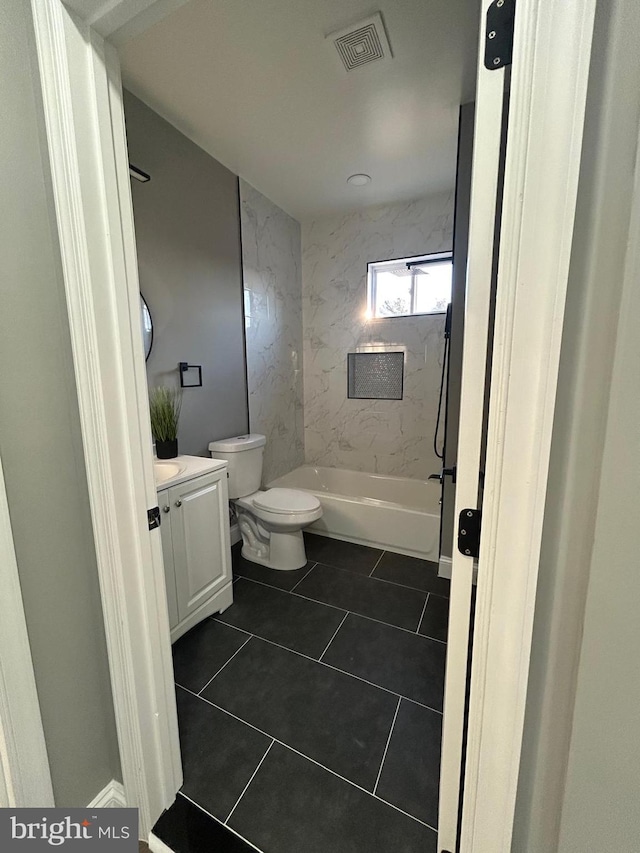 full bathroom featuring tile patterned floors, toilet, vanity, and tiled shower / bath