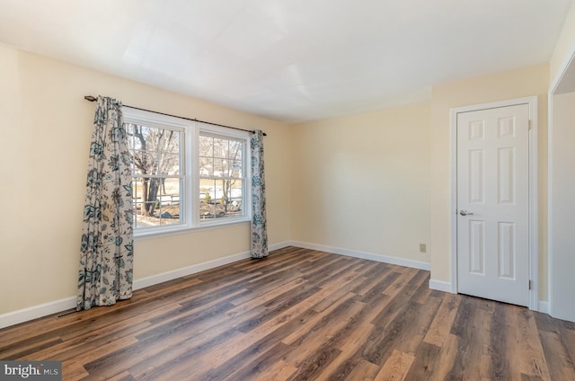 empty room with dark wood-type flooring