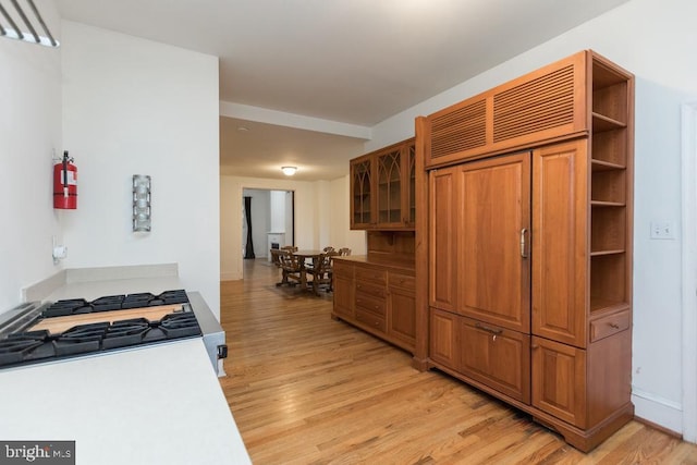 kitchen featuring gas range and light hardwood / wood-style flooring