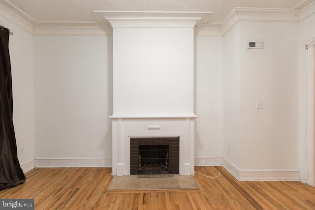 unfurnished living room featuring crown molding and wood-type flooring