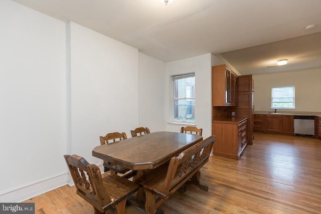 dining room featuring sink and light wood-type flooring