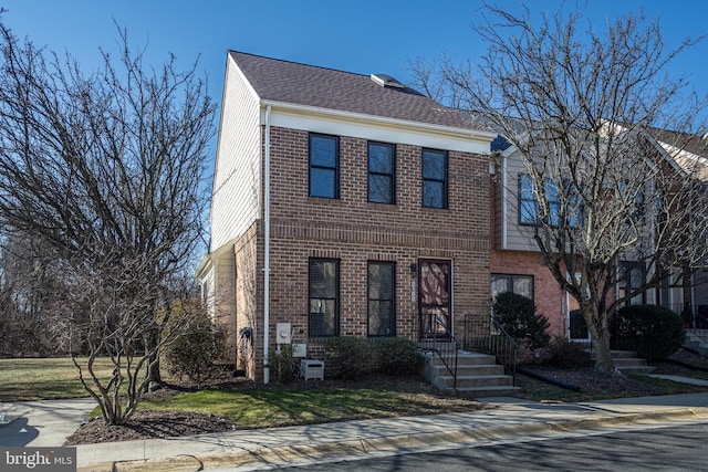 view of property featuring brick siding