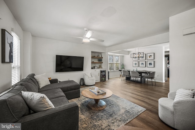 living room featuring dark wood-style floors, wine cooler, baseboards, and a ceiling fan