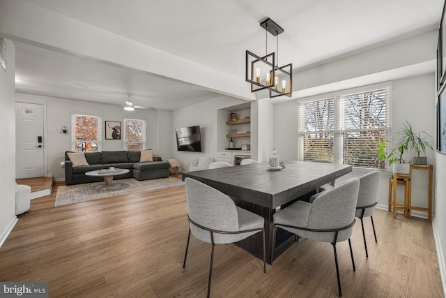 dining space with plenty of natural light, light wood-style flooring, and baseboards