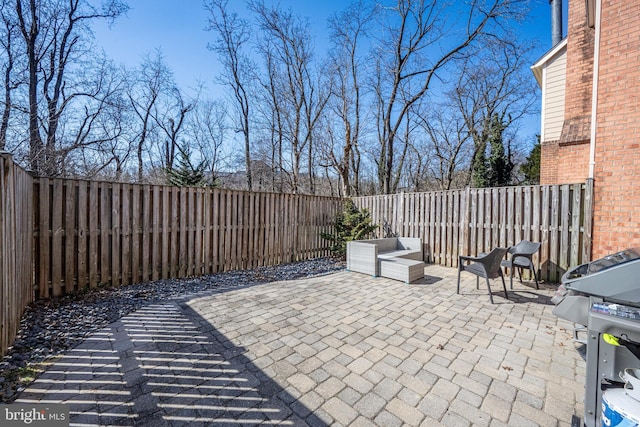 view of patio with a fenced backyard and area for grilling