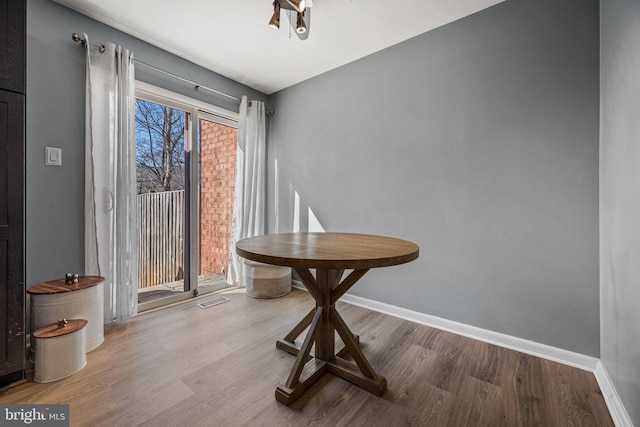 sitting room featuring visible vents, baseboards, and wood finished floors