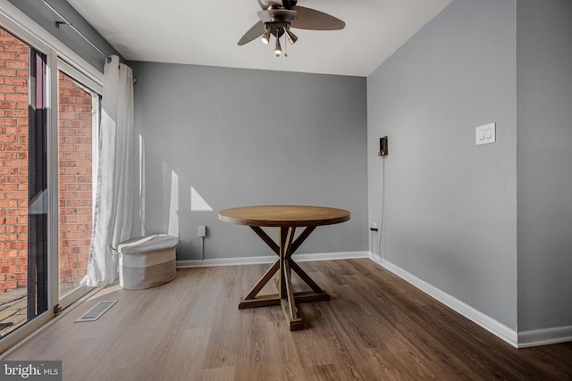 unfurnished dining area with a wealth of natural light, wood finished floors, visible vents, and baseboards