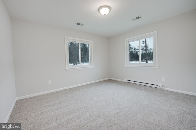 empty room featuring carpet floors and a baseboard radiator