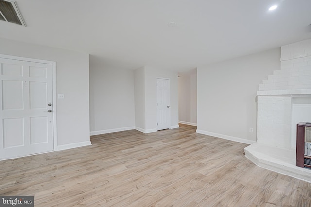 unfurnished living room with light hardwood / wood-style floors