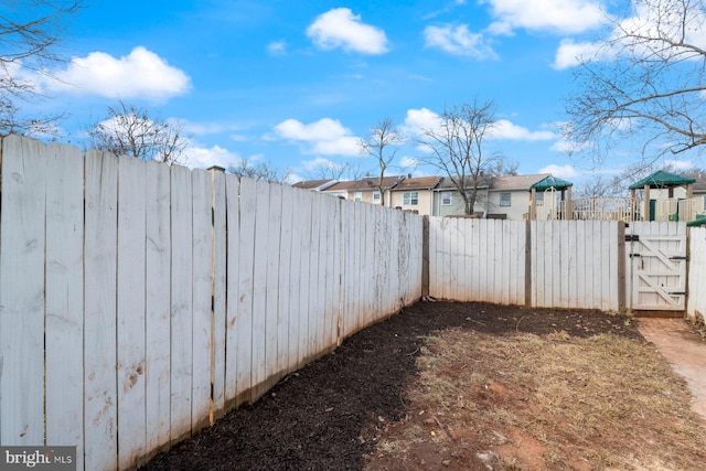 view of yard with fence private yard and a gate