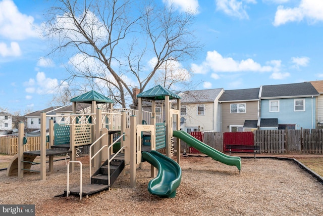 community playground with a residential view and fence