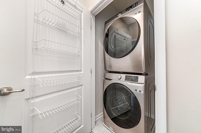 clothes washing area featuring laundry area and stacked washing maching and dryer