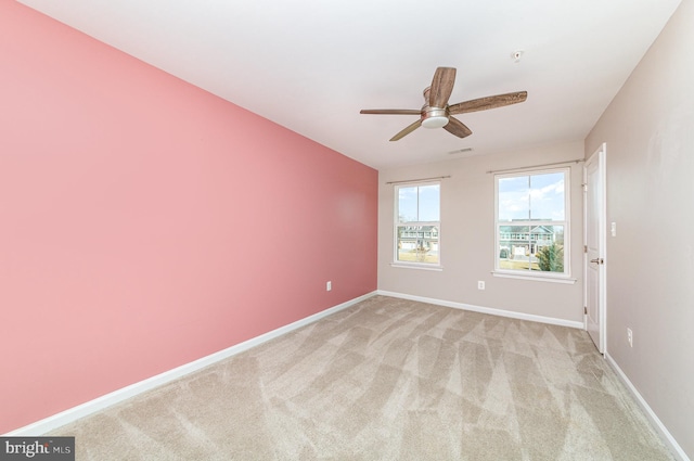 unfurnished room with light carpet, ceiling fan, visible vents, and baseboards