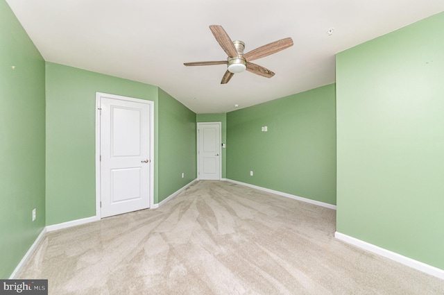 unfurnished bedroom with ceiling fan, carpet flooring, and baseboards