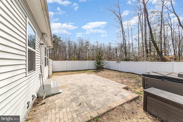 view of patio featuring a fenced backyard and a hot tub