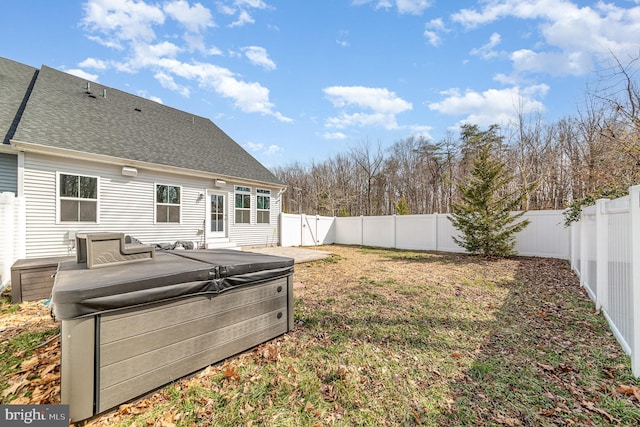 view of yard featuring a fenced backyard and a hot tub