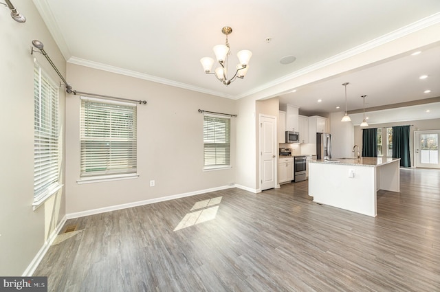 kitchen with baseboards, dark wood finished floors, white cabinets, appliances with stainless steel finishes, and a sink