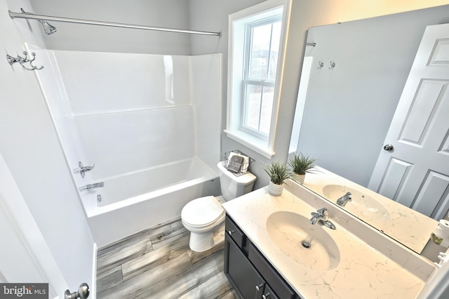 full bathroom featuring toilet, vanity, wood-type flooring, and bathtub / shower combination