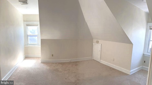 bonus room with carpet, visible vents, and baseboards