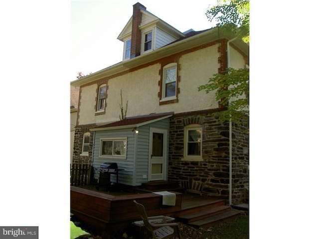 rear view of property with stucco siding