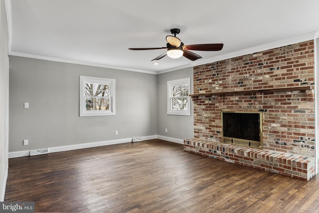 unfurnished living room featuring a brick fireplace, baseboards, dark wood-style floors, and ornamental molding