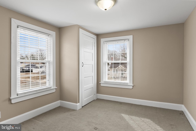 unfurnished bedroom with light carpet and baseboards