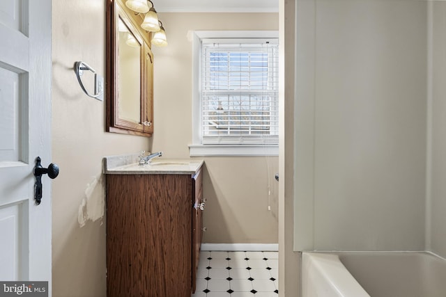 bathroom featuring tile patterned floors, baseboards, ornamental molding, and vanity