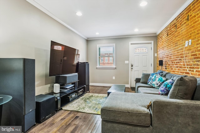 living room with recessed lighting, brick wall, wood finished floors, baseboards, and ornamental molding