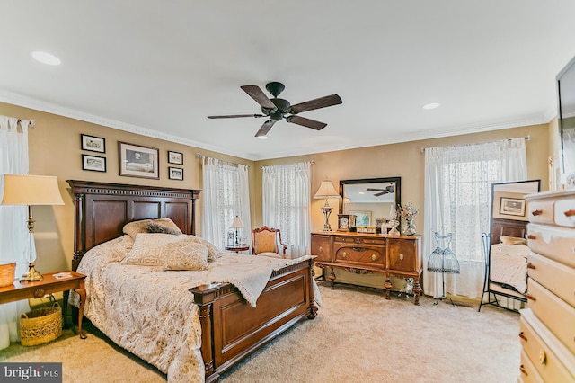 carpeted bedroom with ceiling fan and ornamental molding