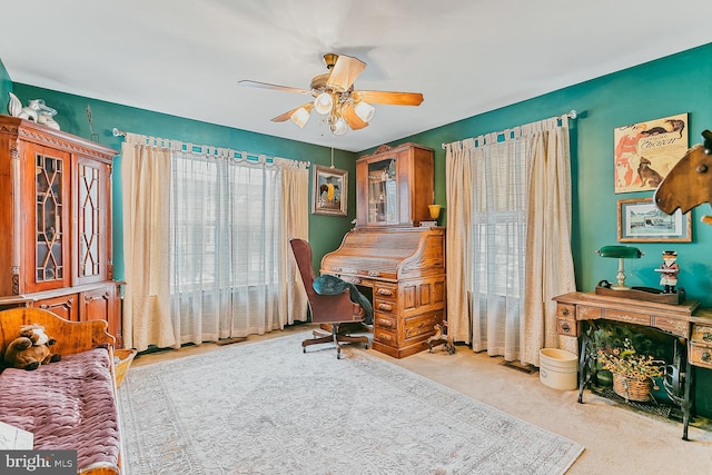 carpeted office with ceiling fan