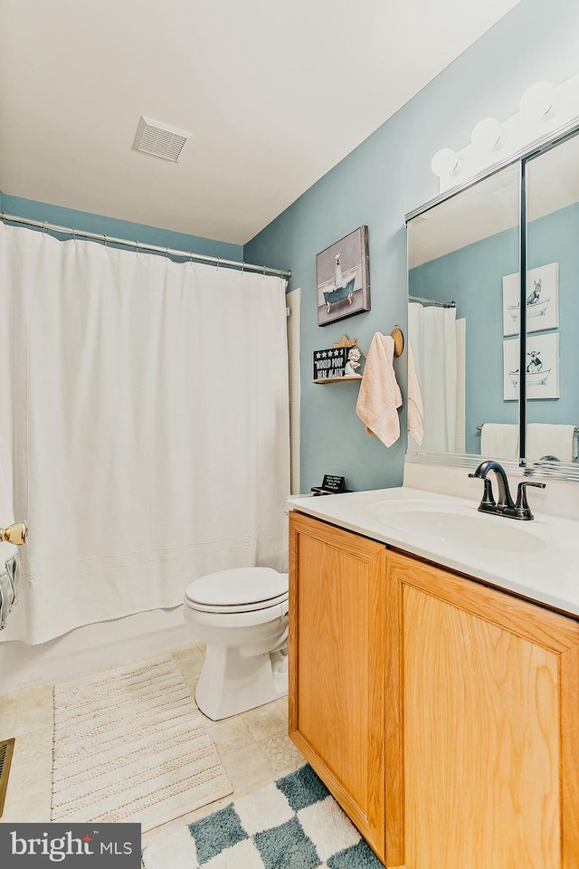 bathroom with tile patterned floors, toilet, vanity, and a shower with shower curtain