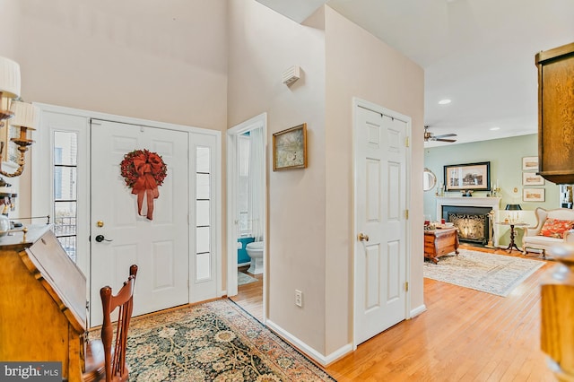 foyer featuring light wood-type flooring and ceiling fan