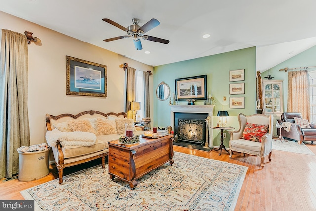 living room with hardwood / wood-style flooring and ceiling fan