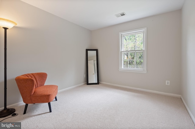 living area with visible vents, carpet flooring, and baseboards