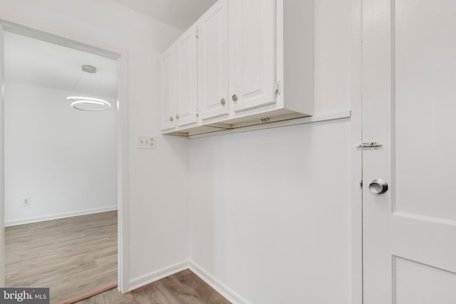 washroom with light wood finished floors and baseboards